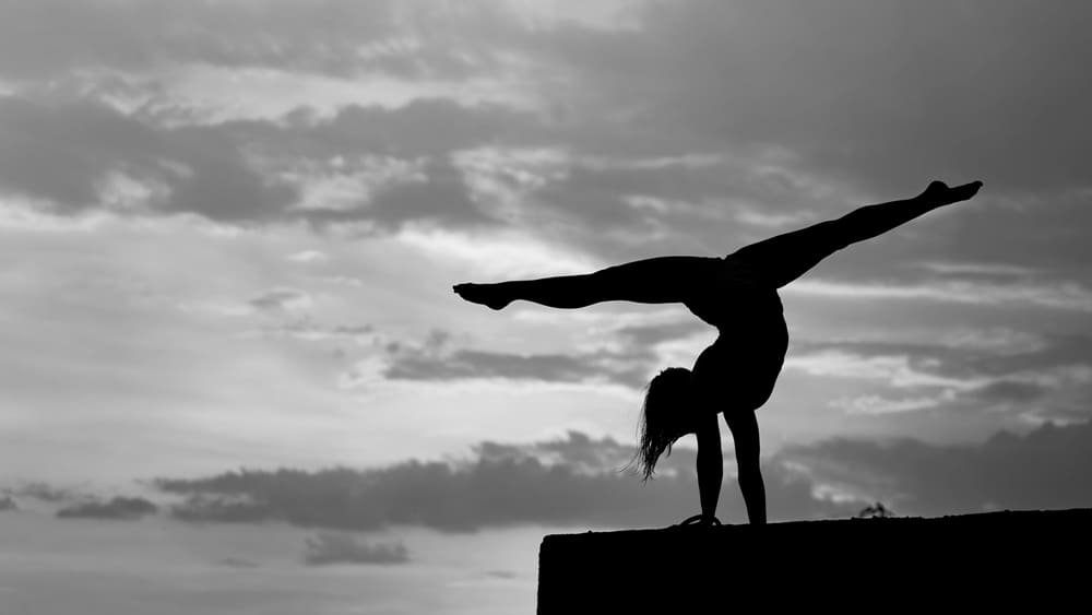 flexible-girl-doing-exercise-sky-background-during-dramatic-sunset.jpg